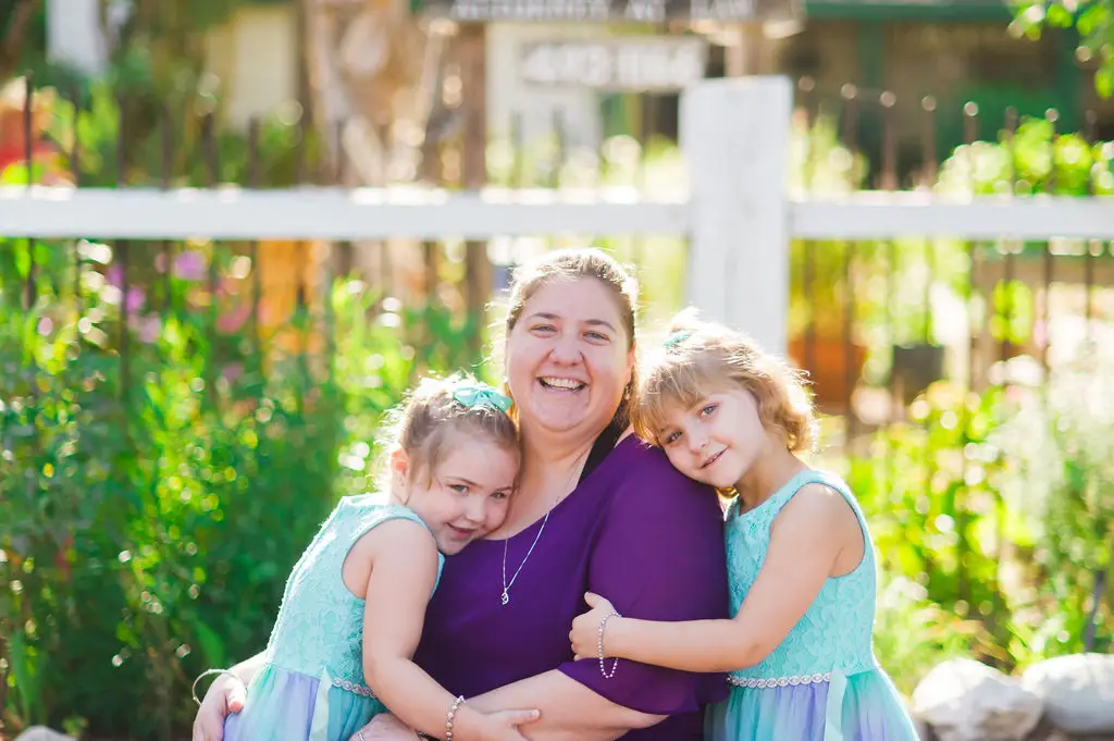 Sarah with her two girls, one on each side